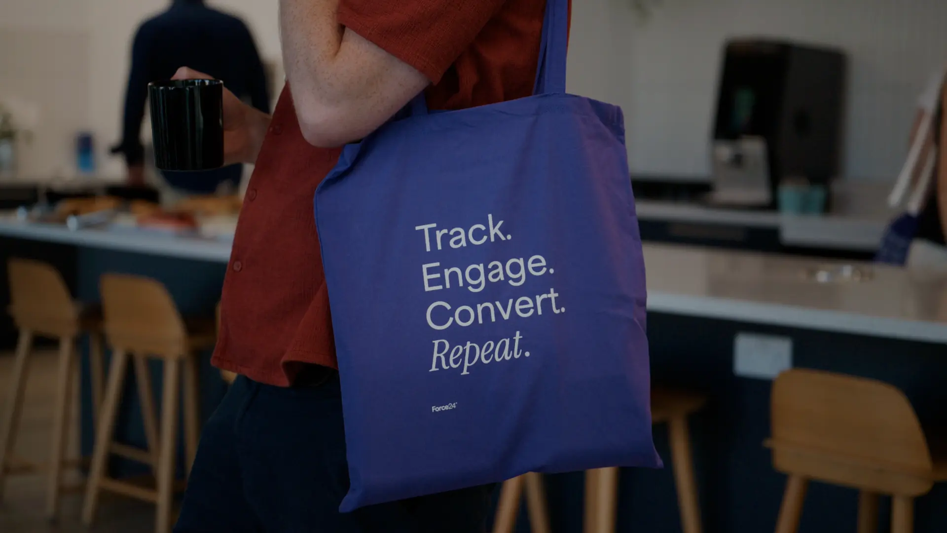 Attendee carrying a Force24 event tote bag